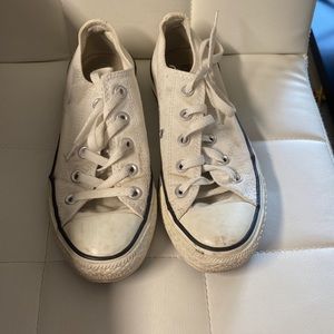 White well worn converse with blue tongue that can be hidden or pulled down.